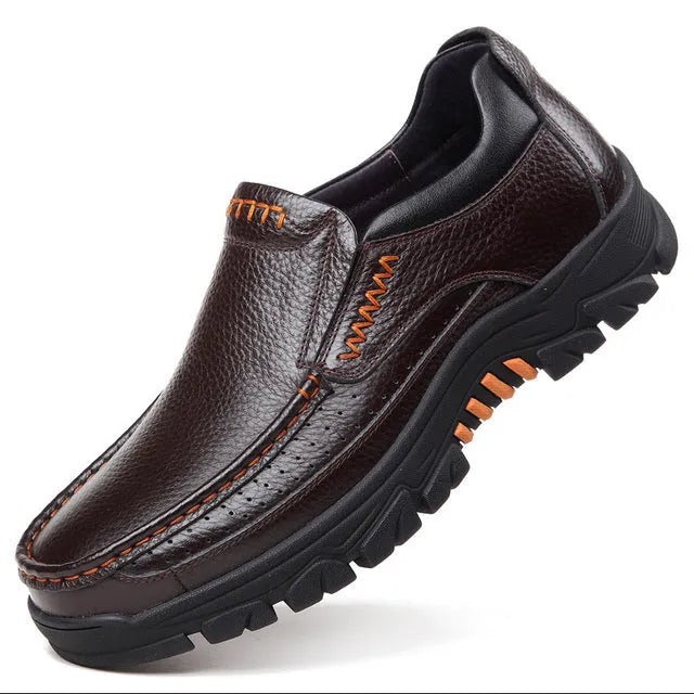 A pair of men's black slip-on business casual shoes made from cowhide leather with a rubber sole.