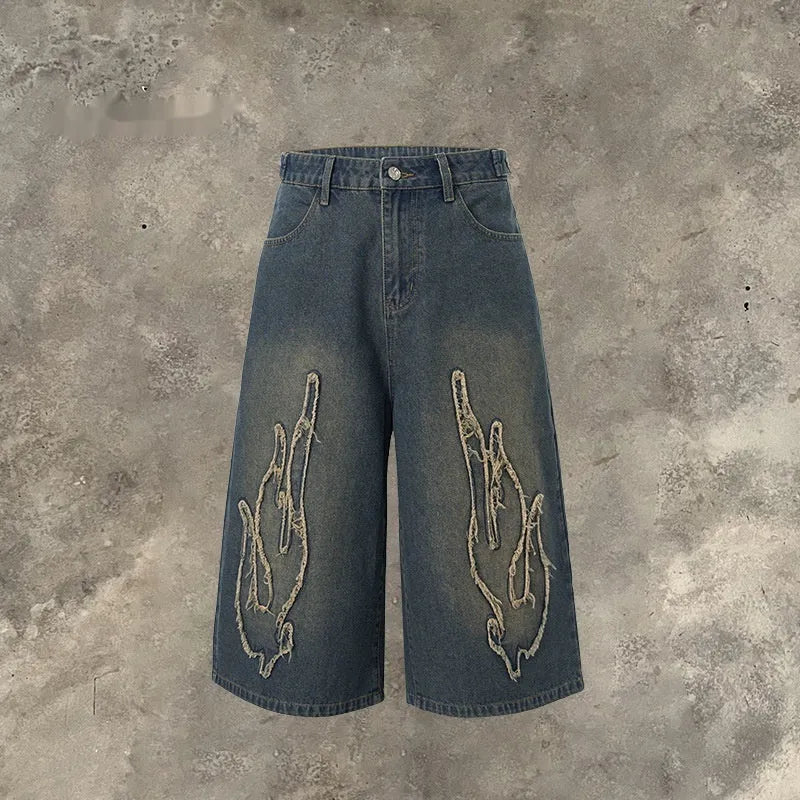 Men's black denim shorts with cropped patch flame embroidery detail, straight leg cut
