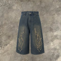 Men's black denim shorts with cropped patch flame embroidery detail, straight leg cut