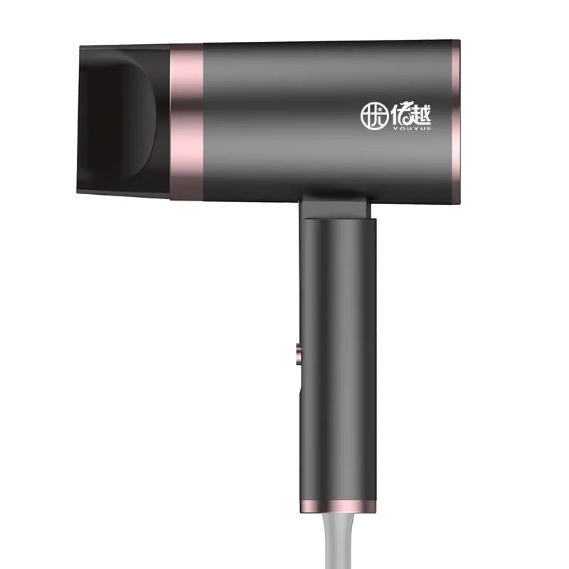 Foldable negative ion hair dryer in emerald green colour with nozzle attached