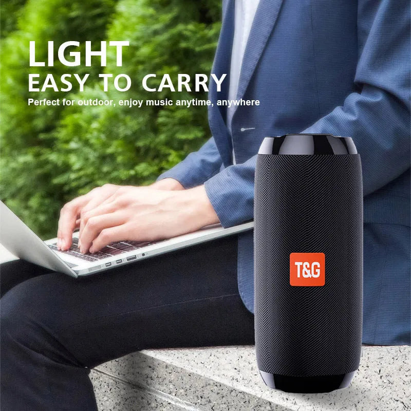 Portable IPX5 waterproof Bluetooth speaker in black with mesh grille and cylindrical design