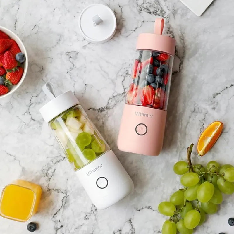 White portable USB rechargeable blender bottle with silicone lift ring, shown next to its charging cable.