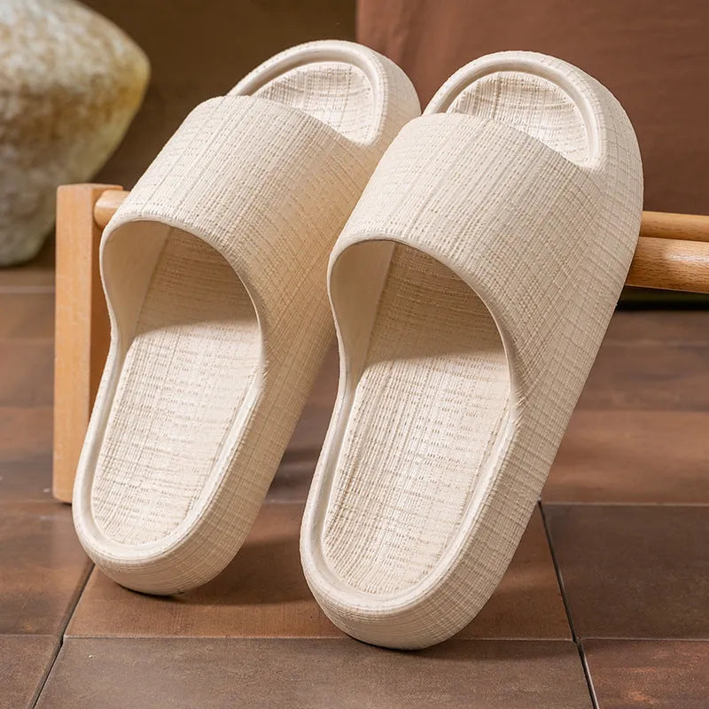 Pair of EVA toe ring flip flop slippers on a wet floor, showing non-slip sole pattern.