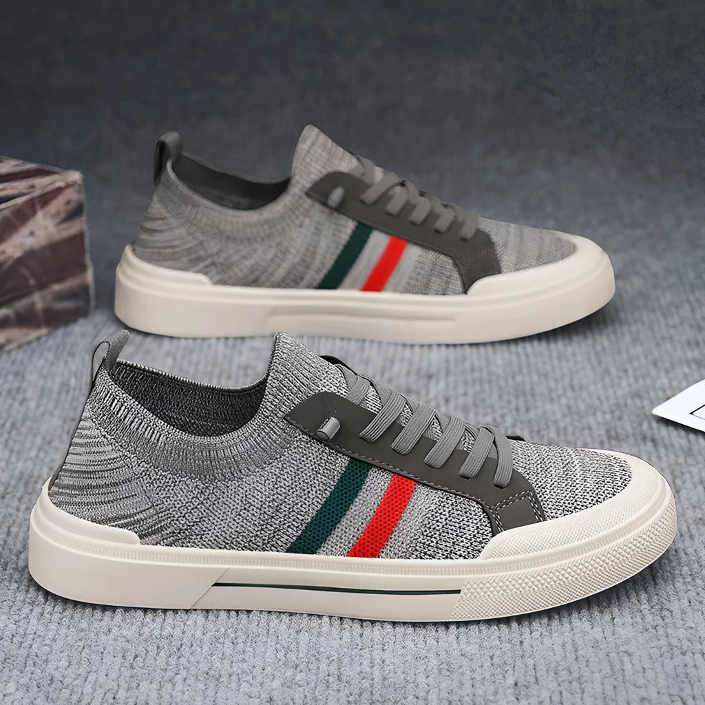 Beige men's low-top casual sneakers with mesh upper, elastic band, and flat rubber sole.