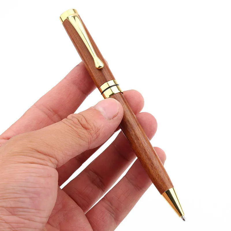 Gold metal and rosewood ballpoint pen 14cm long with cap