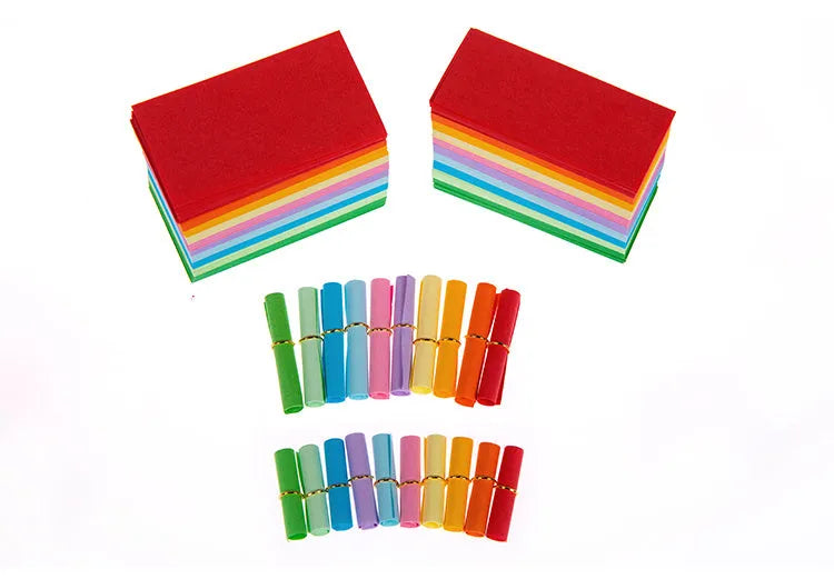 Colourful miniature paper scrolls for drift bottle messages with central eyelet for string attachment
