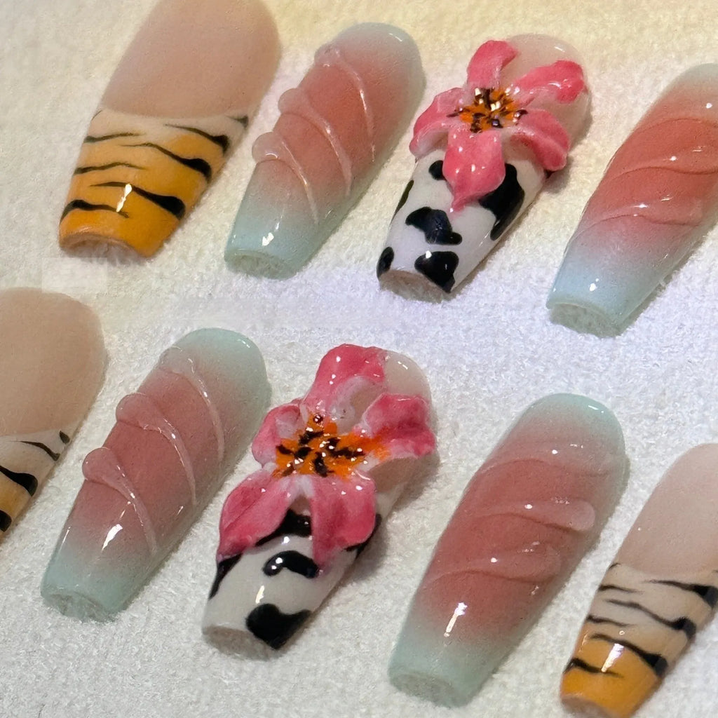 Set of false nails with hand-carved zebra pattern and lily design, showing sizes XS S M L and leopard print styles.