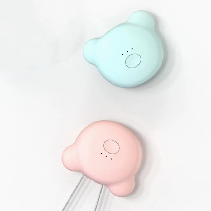 Mini USB portable air purifier necklace in pink, showing compact size and wearable design.