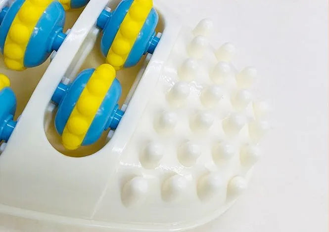 White plastic foot acupressure massager roller with ridged surface for plantar fasciitis and arch pain relief