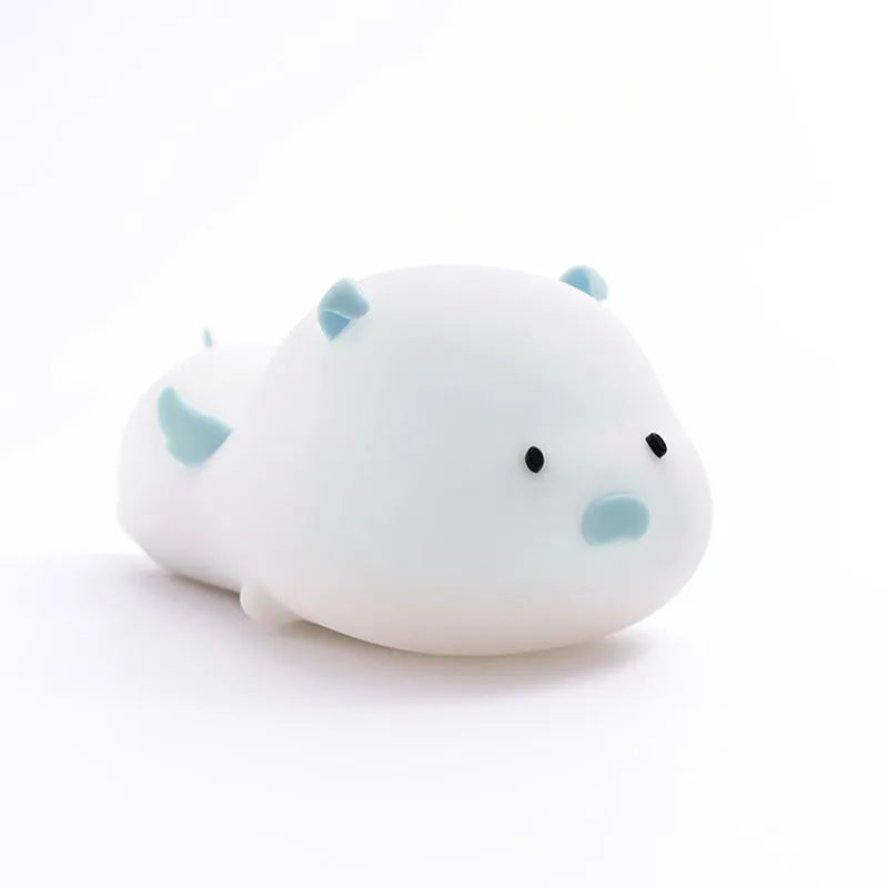 Blue or pink pig silicone night light with sleeping design, shown with dimensions and rechargeable battery.