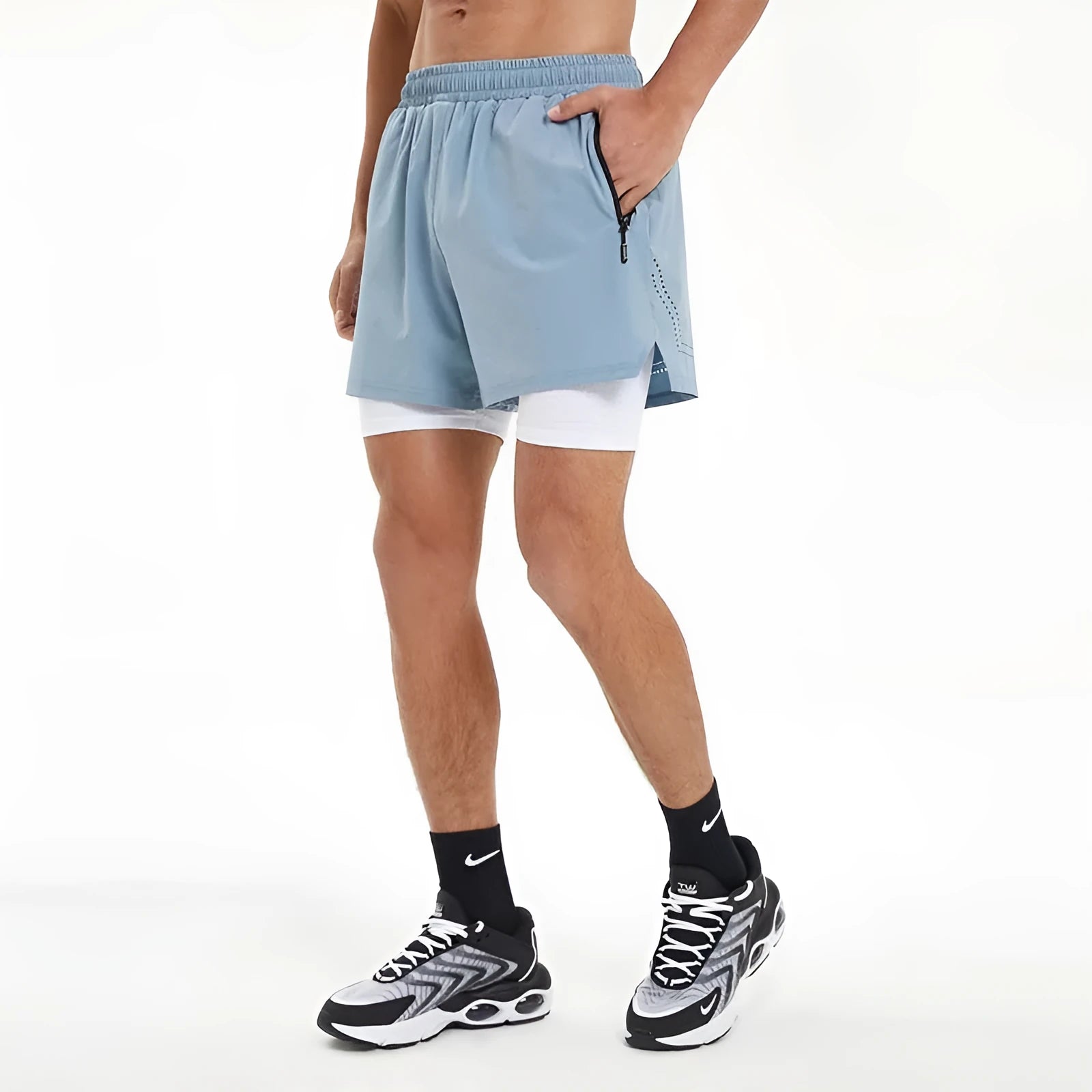 Men's black double-layer running shorts with an inner liner, shown on a size chart.