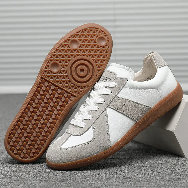 White Japanese-style retro low-top sneakers with mesh lining and a flat rubber sole on a plain background.