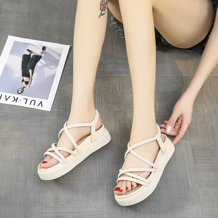 Women's black roman style platform sandals with straps on a white background.