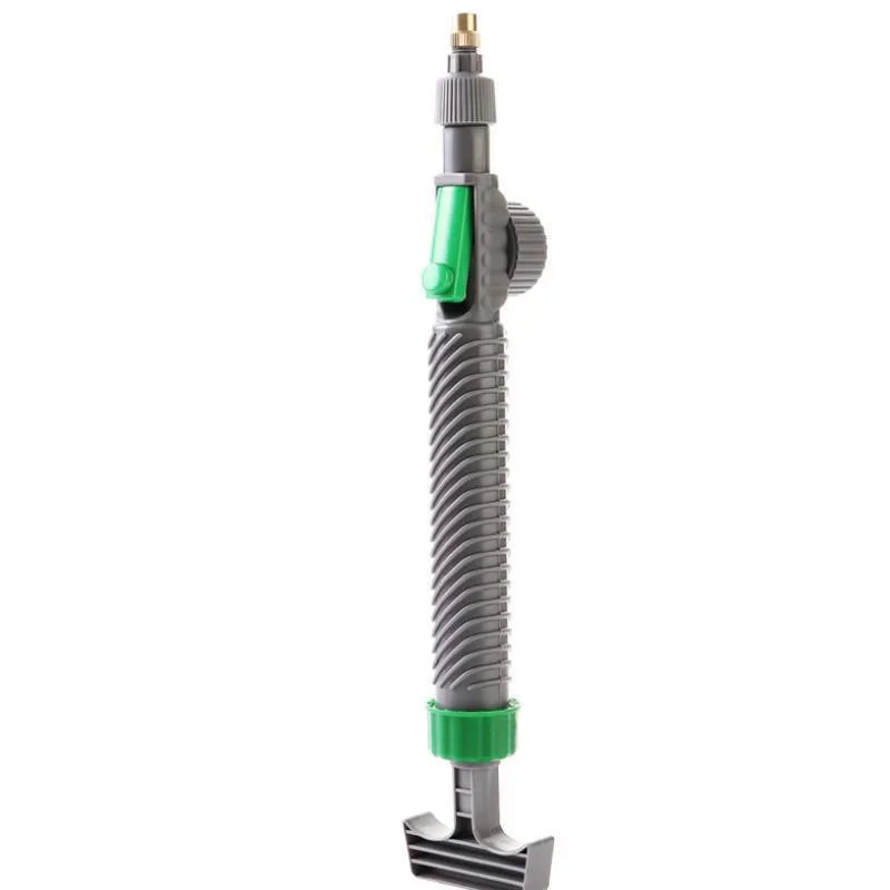 Plastic watering sprayer nozzle with extension tube attached to a large clear beverage bottle.