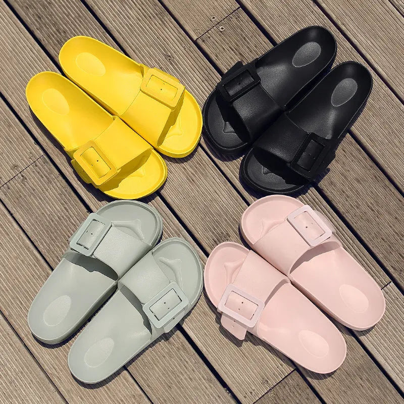 Women's grey blue EVA flip-flop sandals with a silver buckle on the strap, showing flat sole.