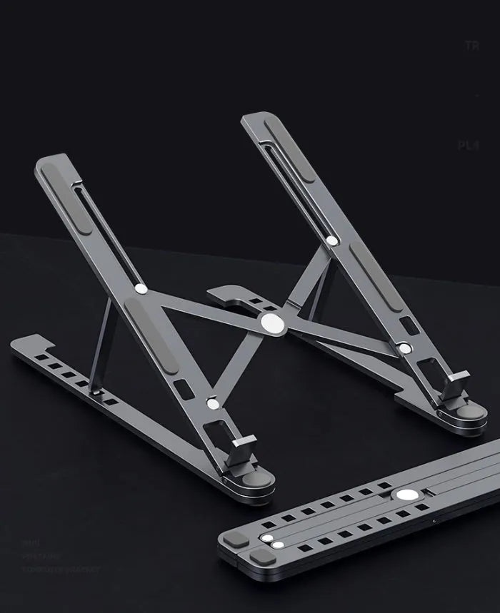 Silver foldable aluminium laptop stand holding a MacBook at an adjusted angle