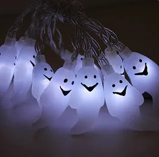 Halloween LED string lights with pumpkin, bat, and ghost decorations hanging on a wall