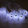 Halloween LED string lights with pumpkin, bat, and ghost decorations hanging on a wall