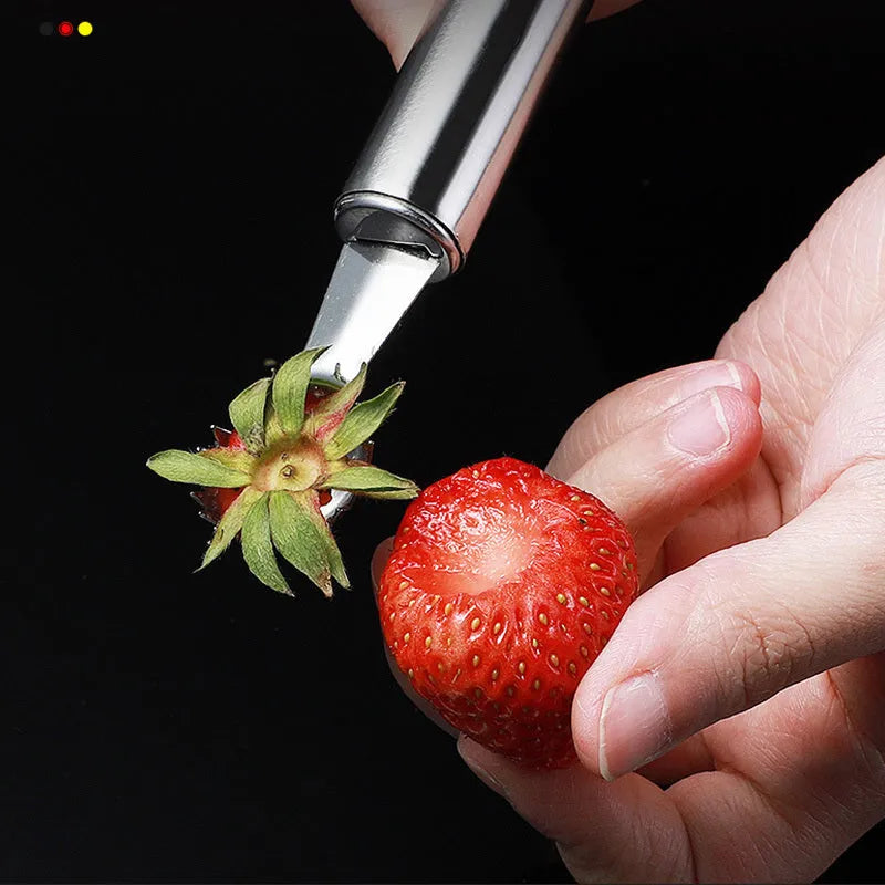 Stainless steel strawberry stem remover on a kitchen counter, modern minimalist design for coring fruit