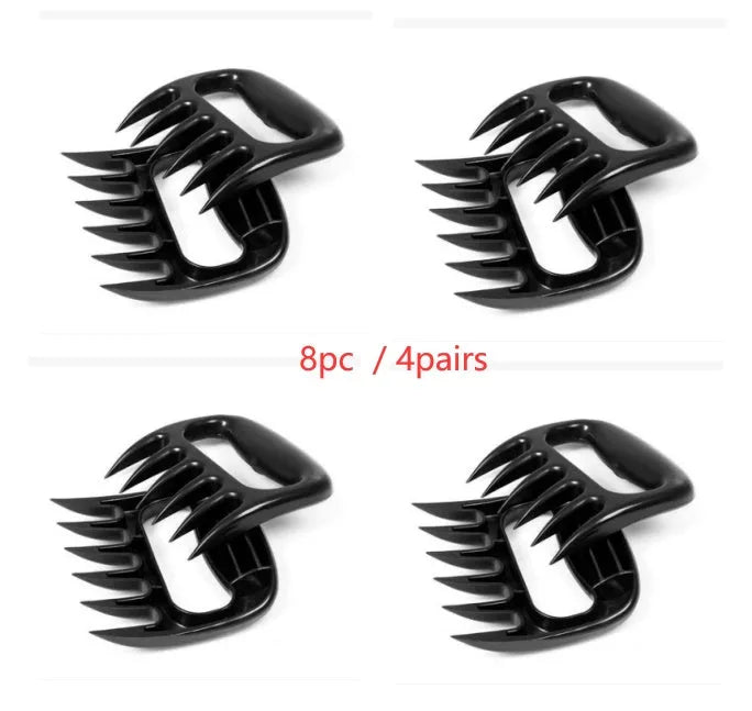 Two black bear claw meat shredder forks for pulling pork and BBQ preparation.