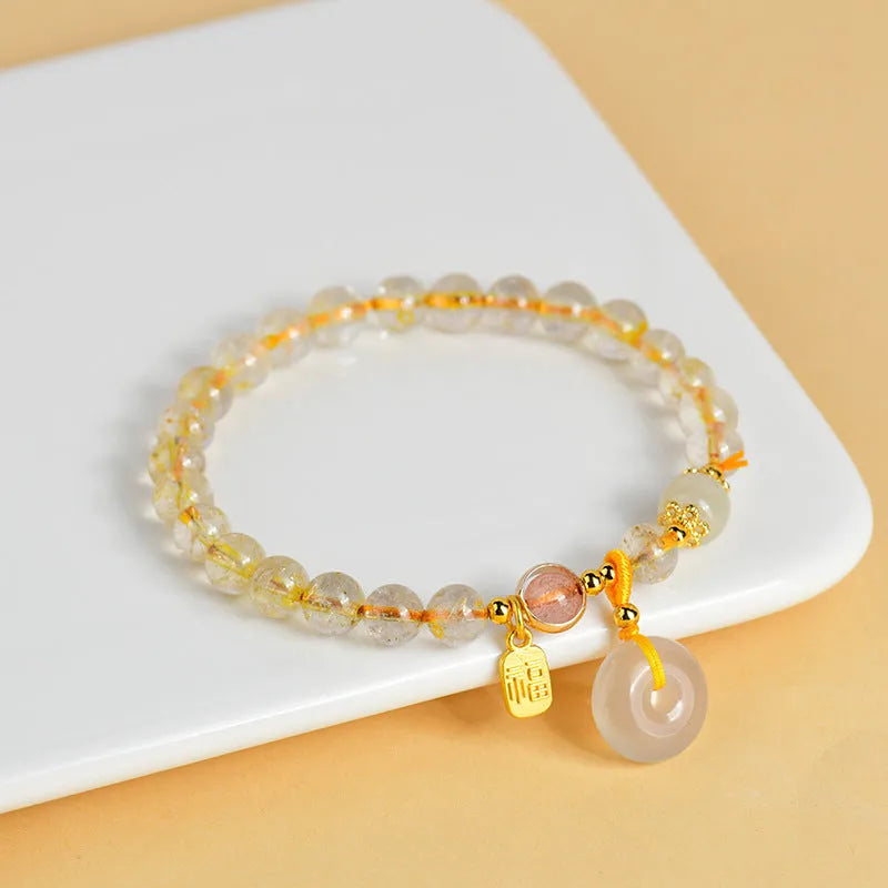 Gold rutilated quartz crystal bracelet with geometric design and safety buckle