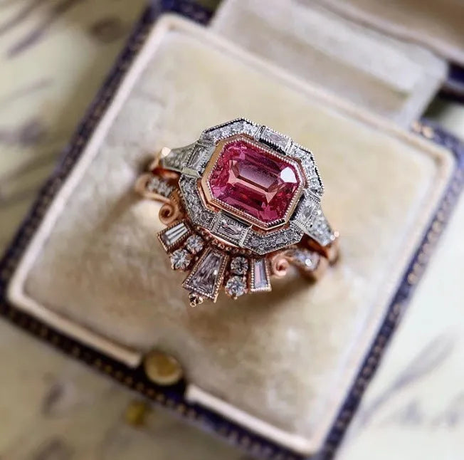 Rose gold coloured alloy women's ring with a geometric retro ruby style design on a hand.
