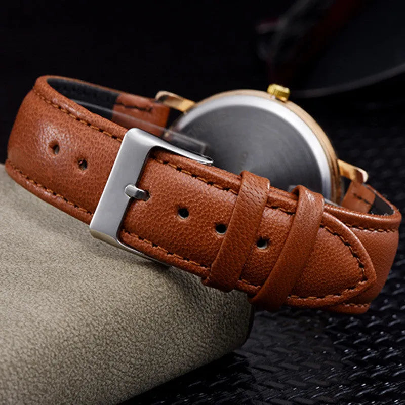 Love Tree round dial leather strap casual wrist watch in black on a tabletop