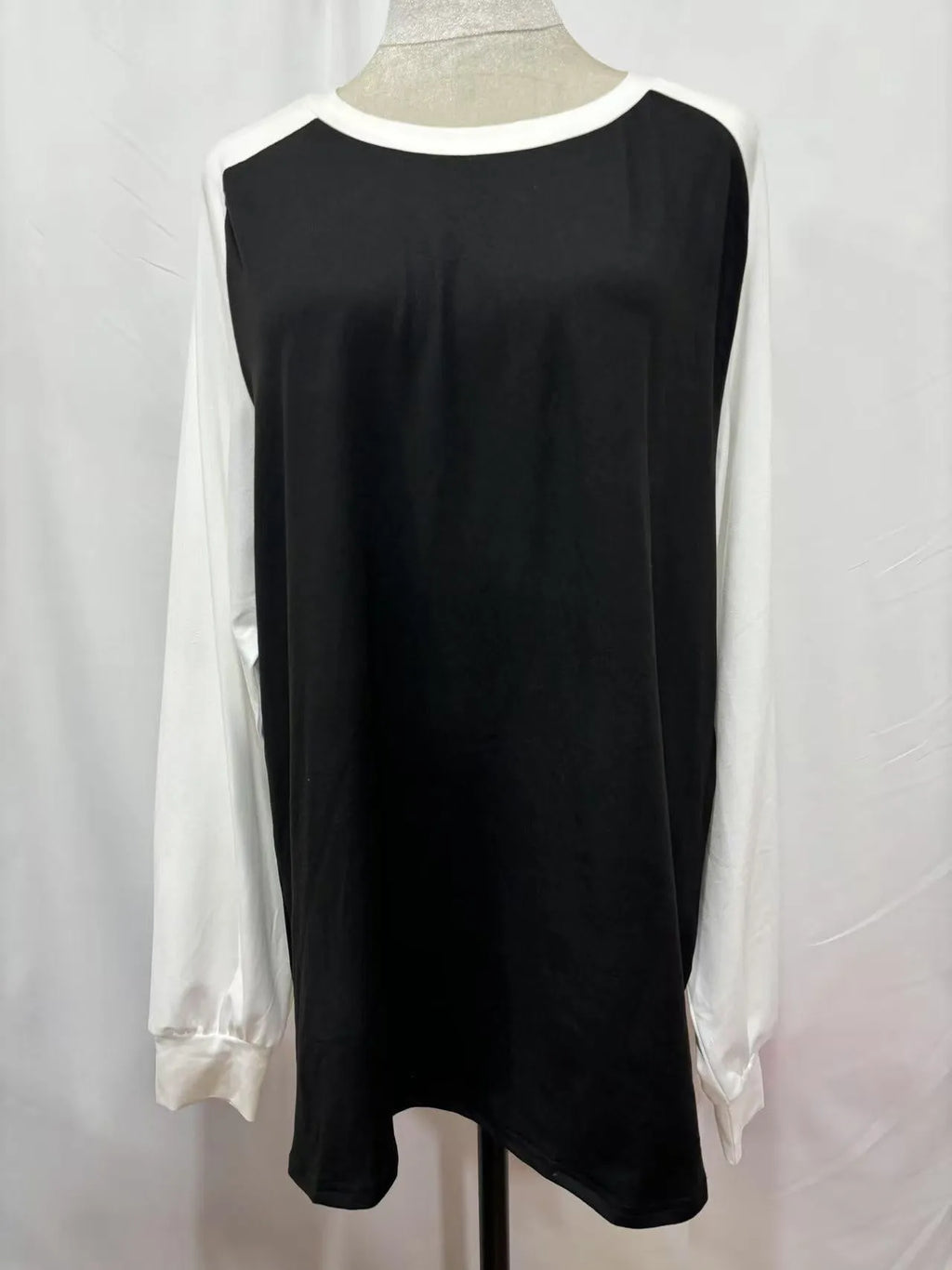 Long sleeve solid colour T-shirt in black, blue, grey, or pink on a hanger