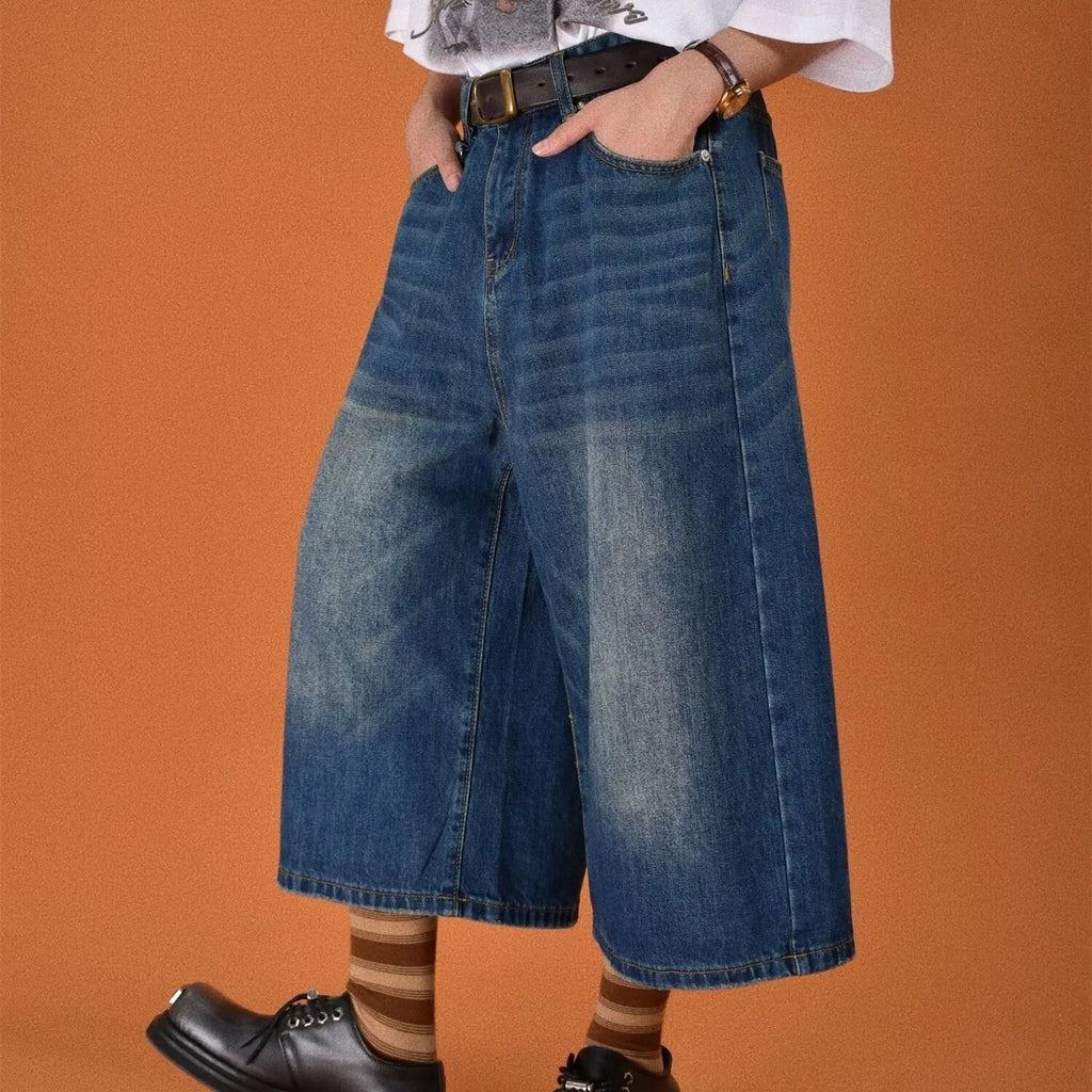 Men's loose fit straight leg denim shorts in blue, shown at a fifth pants length.