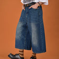 Men's loose fit straight leg denim shorts in blue, shown at a fifth pants length.