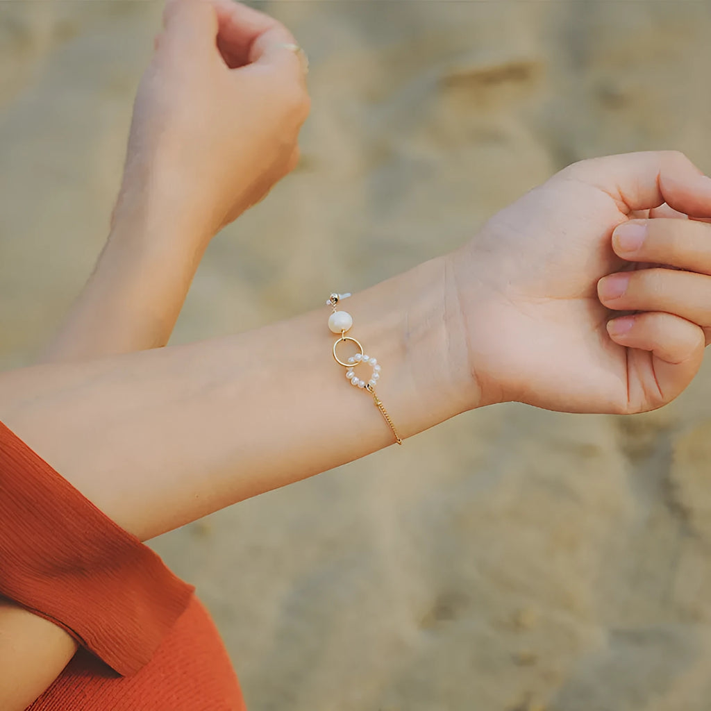 Natural pearl women's bracelet with a 14k gold-plated setting on a single strand.