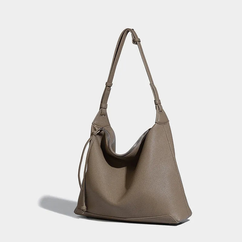 Large caramel coloured PU messenger bag with shoulder strap showing 36cm length