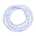 Blue agate bracelet with striped beads and a Ruyi charm on a wrist.
