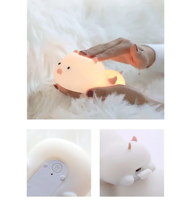 Blue or pink pig silicone night light with sleeping design, shown with dimensions and rechargeable battery.