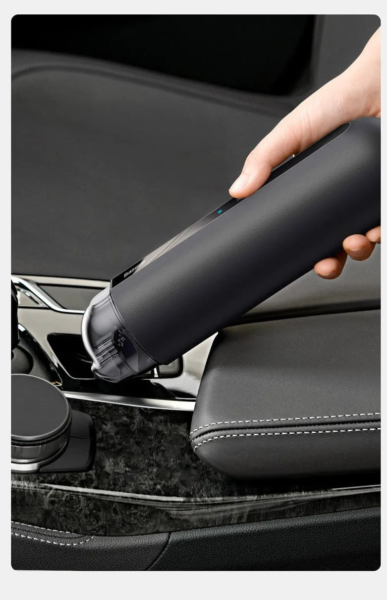 Starry sky black handheld cordless car vacuum cleaner with blowing hose accessory on a desktop.