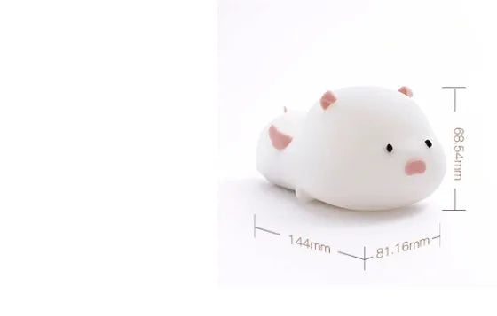 Blue or pink pig silicone night light with sleeping design, shown with dimensions and rechargeable battery.