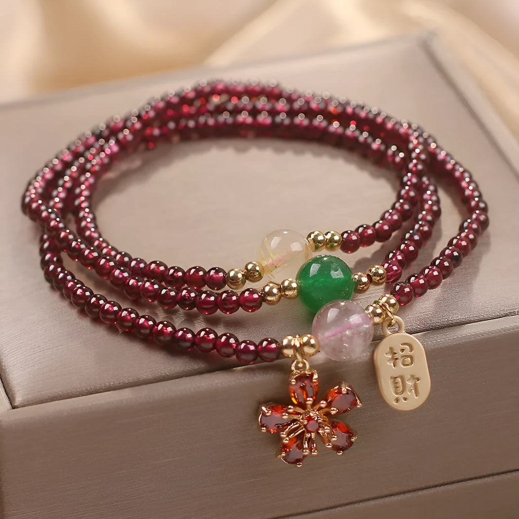 Women's crystal bracelet in pomegranate red cherry blossom colour with simple sequin detail on wrist