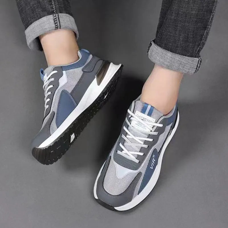 Men's black and grey colour block mesh running shoes with white soles on a plain background.