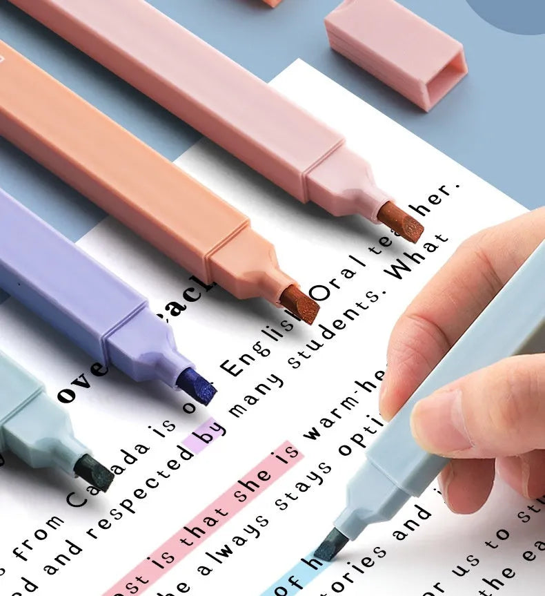Set of double-headed fluorescent marking pens in bright colours on a white background.