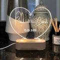 Custom transparent acrylic night light engraved with personal names and a date.