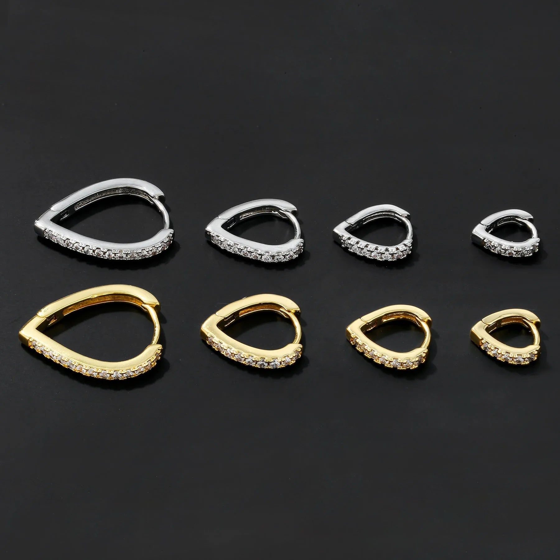 A geometric heart-shaped ear clip for women in electroplated copper, shown in gold and white K colour options.