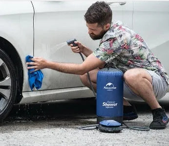 Rinse Pro blue portable outdoor shower water bag with 200cm hose and nozzle on grass