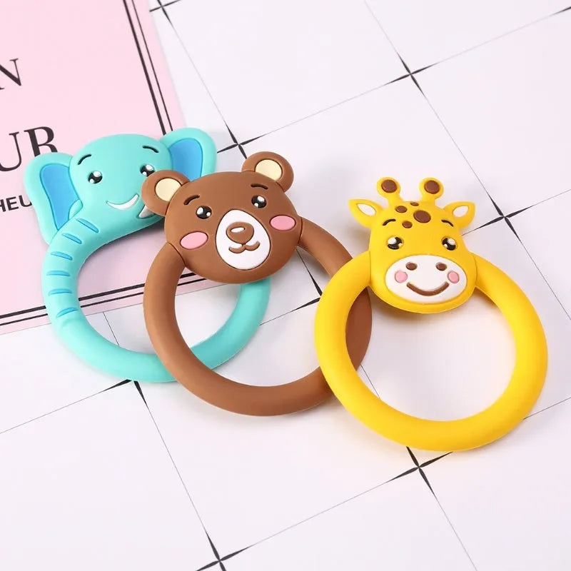Three silicone baby molar teethers in brown, blue, and yellow on a white background