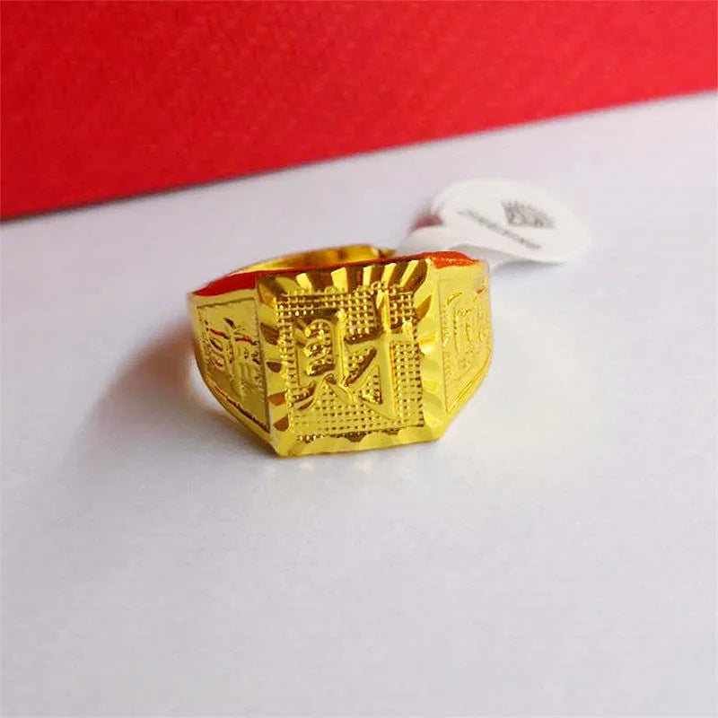 Square men's alloy ring with electroplated yellow finish on plain background