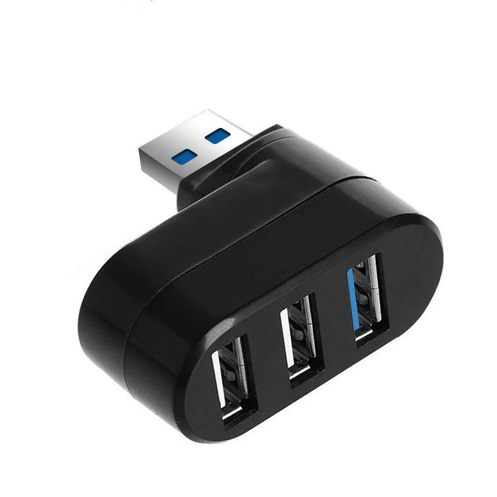 Black and white USB 3.0 four-port rotary splitter hub on a desk next to a laptop