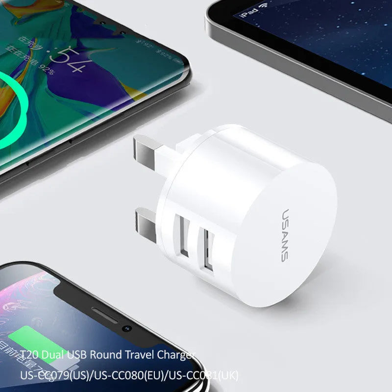 White portable universal dual USB phone charger with foldable US, EU, and UK plugs showing 39mm diameter