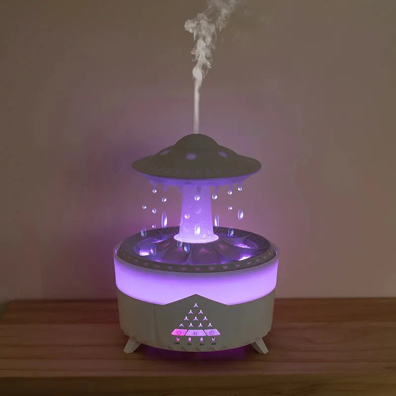 UFO cloud-shaped humidifier with LED lights and water droplet effects on dark surface