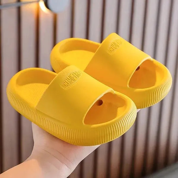 Children's mixed colour EVA slippers with textured non-slip soles and 1.5cm thick cushioning.