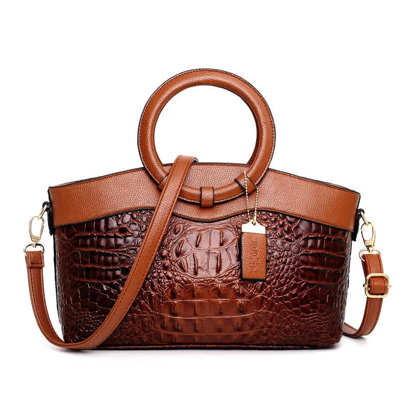 A casual fashion ladies' fabric handbag with a shoulder strap, shown in a choice of colours, featuring multiple zippered compartments.