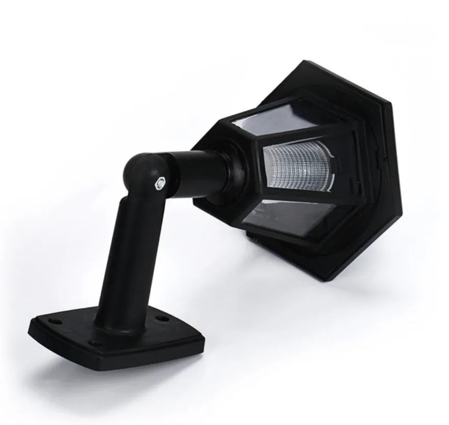 Black hexagonal solar wall light with solar panel for outdoor garden installation